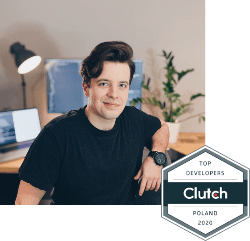 Wojciech Kałużny sitting in front of his desk with Clutch Top Developer in Poland badge